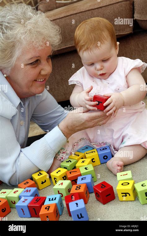 Six Month Old Baby Playing With Building Blocks With Grandmother Stock