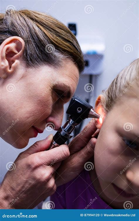 Female Doctor Examining Patient Ear With Otoscope Royalty Free Stock