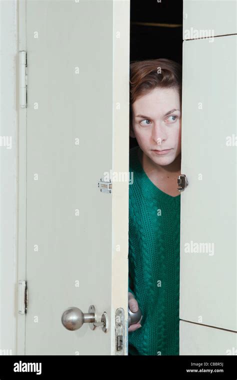 Man Peeking Through Doorway Stock Photo Alamy