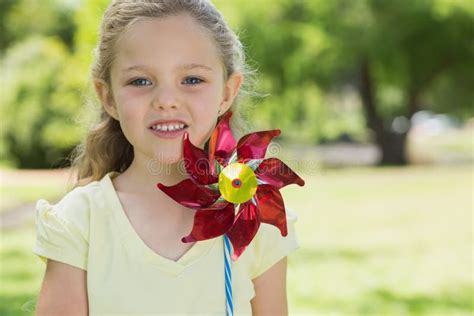 Portrait Of Cute Girl Holding Pinwheel At Park Stock Image Image Of