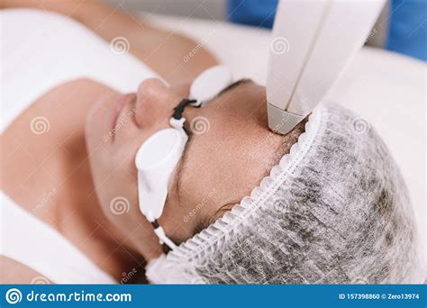 Woman Getting Laser Hair Removal Procedure By Beautician