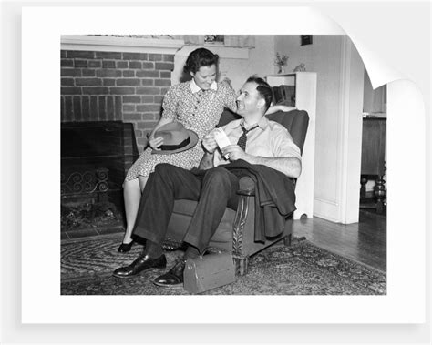 1940s Smiling Man Sitting In Chair Holding Pay Envelope While Wife Sits