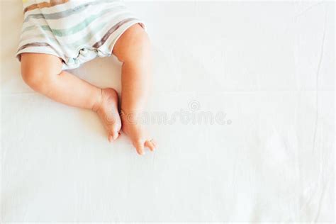 Little Feet Of Baby On White Linens Background Mockup Top View Copy