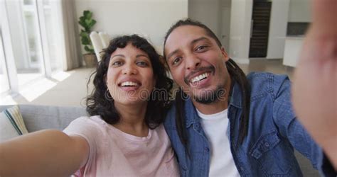 Happy Biracial Couple Sitting On Couch Taking Selfies In Living Room Stock Video Video Of