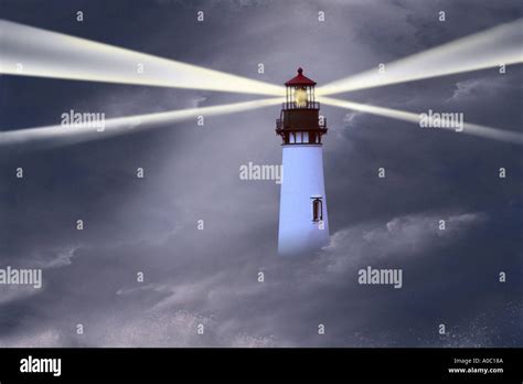 Lighthouse In Storm With Beams Stock Photo Alamy