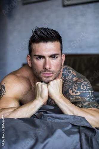 Shirtless Muscular Sexy Male Model Lying Alone On Bed In His Bedroom