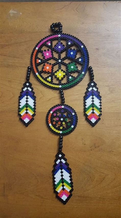 A Colorful Beaded Dream Catcher Hanging On A Wooden Table