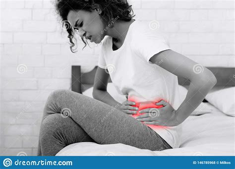 Woman Touching Left Side Suffering From Stomach Ache Stock Photo