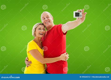 Composite Image Of Happy Mature Couple Taking A Selfie Together Stock