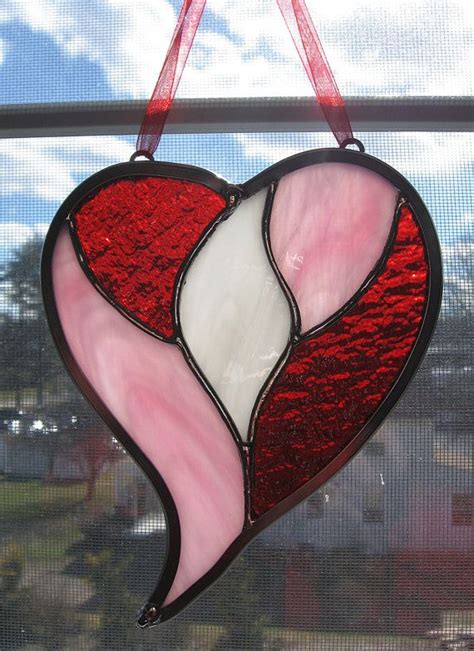 A Stained Glass Heart Hanging From A Window