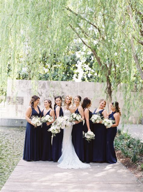 Southern Navy Bridesmaid Dresses With White Bridal Party Florals At