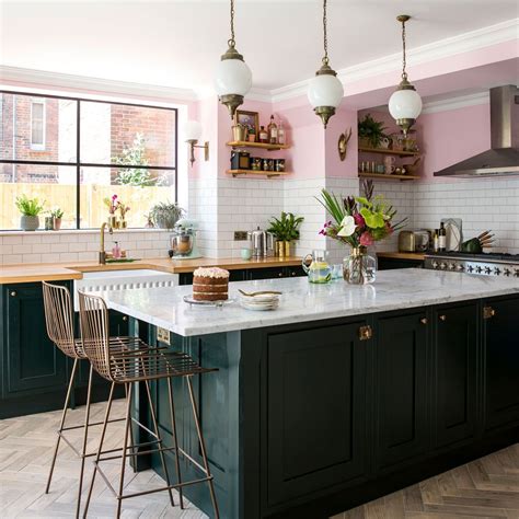 Kitchen features a plank ceiling over sage green cabinets with brass pulls, sage green wooden kitchen hood over white marble slab backsplash, polished nickel swing arm pot filler. 17 Gorgeous Green Kitchens that inspire in 2020 | Green ...