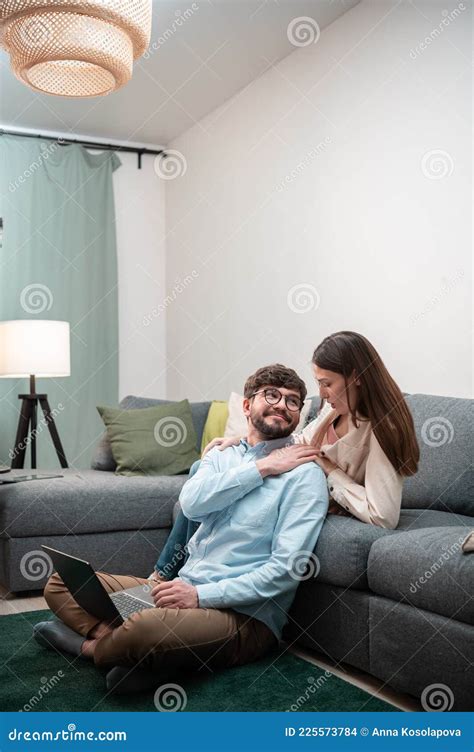 Caring Wife Gives Her Husband A Shoulder Massage While He Works