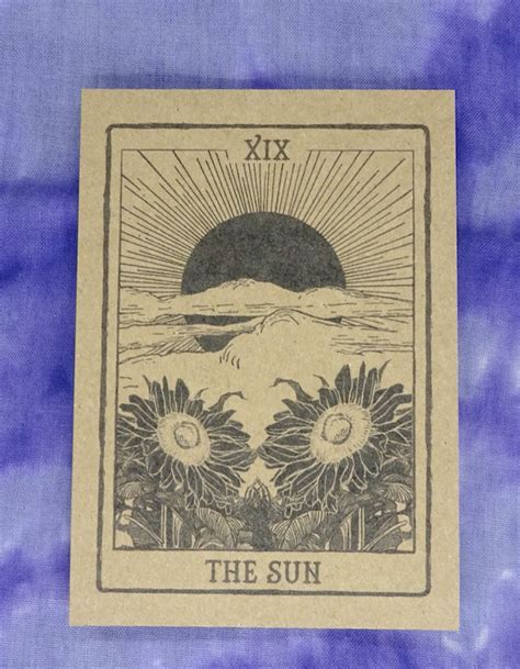The Sun Tarot Card On A Blue Tie Dye Background