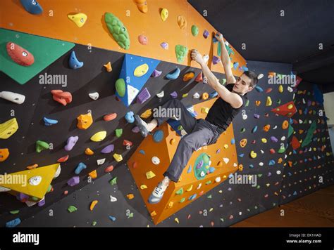 Young Man Practicing Bouldering In Indoor Climbing Gym Stock Photo Alamy