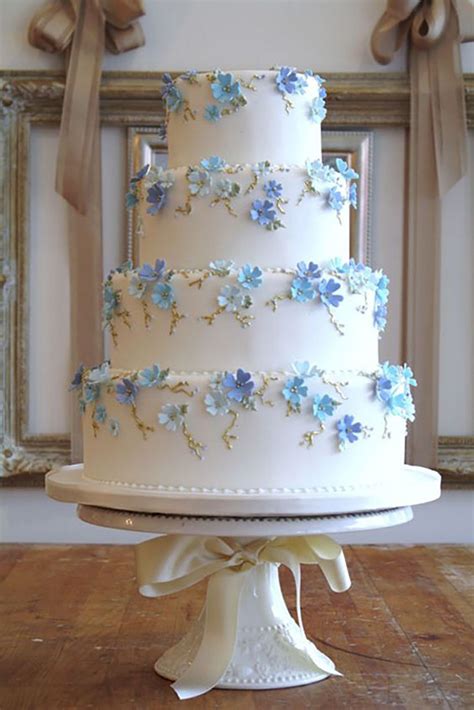 Because finding the perfect wedding cake isn't always a piece of cake. Tiered wedding cake with blue flowers | Classic wedding ...