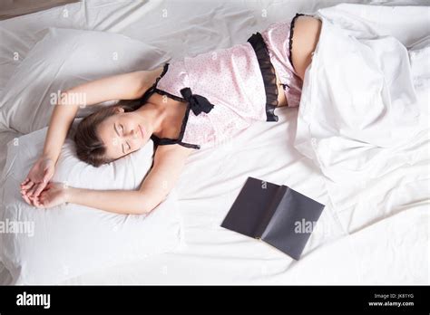 Girl In Pajamas Lying On The Bed With A Book Before Bed Stock Photo Alamy