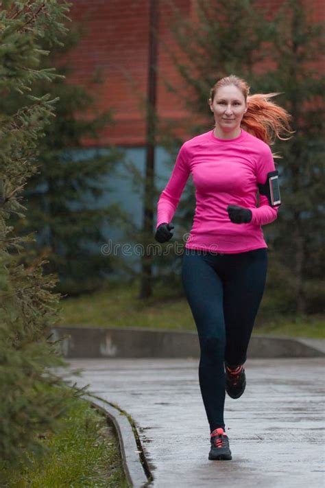 Woman In Pink Running In Autumn Park Female Runner Outdoor Healthy