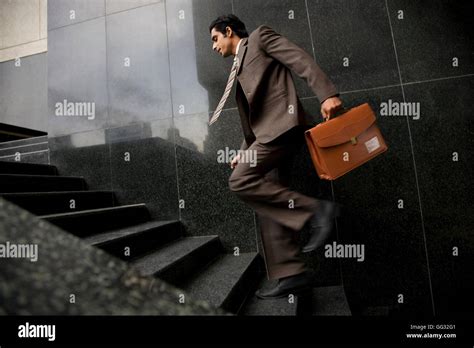Executive Running Up The Stairs Stock Photo Alamy