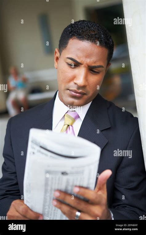 Close Up Of A Businessman Reading A Newspaper Stock Photo Alamy