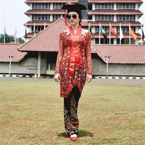 image may contain 1 person standing and outdoor model dress kebaya model kebaya modern