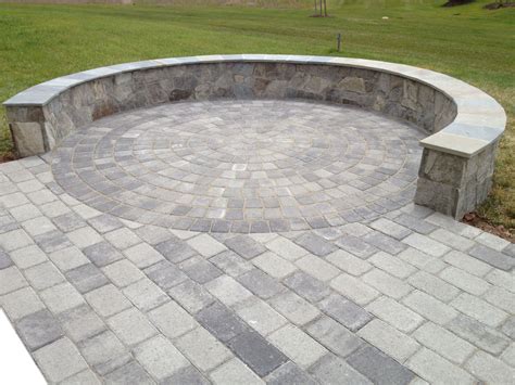A Beautiful Paver Patio With A Stone Seatingborder Wall On A Circle