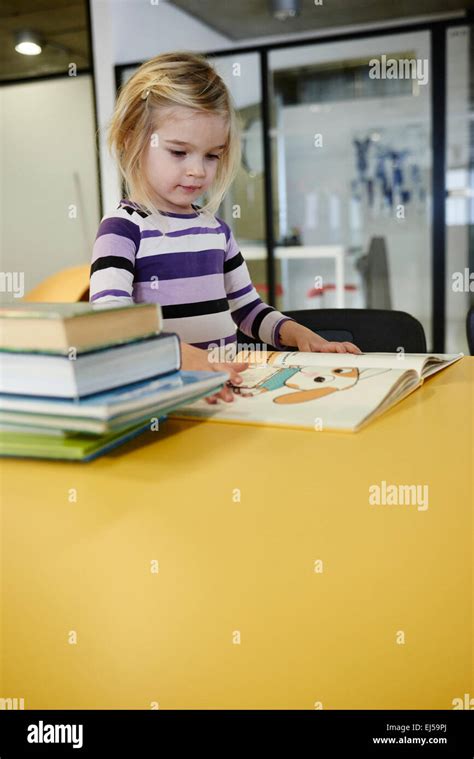 Caucasian Child Blond Little Girl Looking Reading And Choosing