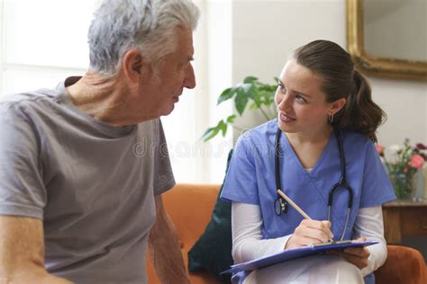 Young Nurse Checking Elderly Senior In His Home Stock Photo Image Of