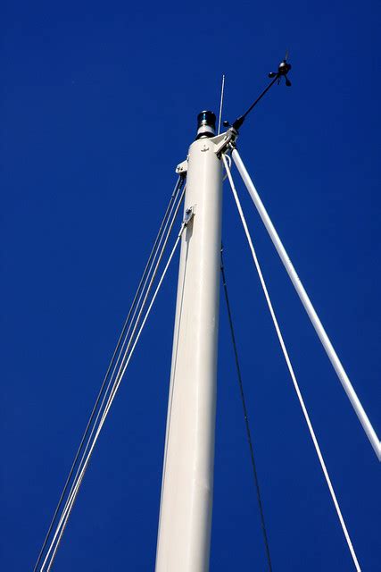 Nautical Photo Of The Daybright White Sailboat Mast Against A Vibrant