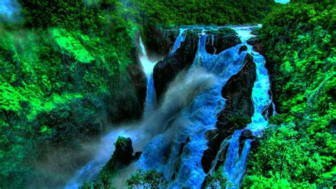 Deep In The Jungle Beautiful Waterfall In Tropical Green