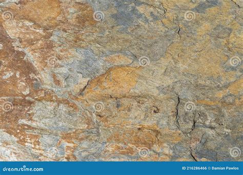 The Texture Of Rough Stone Wall Covered With Rust As Background Stock