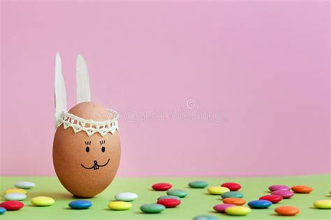 Cute Handmade Egg Bunny On Pink Background With Colored Candies Happy