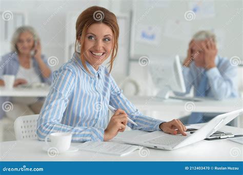 Beautiful Young Woman Working In Office Colleagues On Bckground Stock