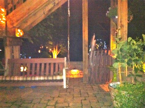 Swimming pool at night with city views from the distance. Backyard at Night | Outdoor decor, Backyard, Porch swing