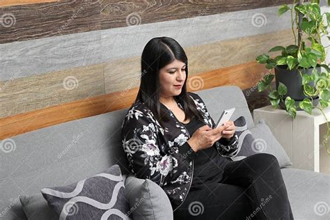Latin Adult Woman Uses Her Cell Phone To Send And Receive Messages