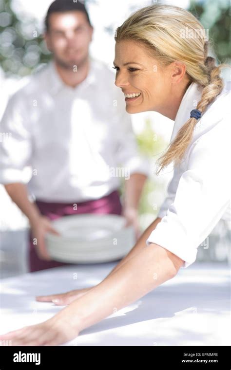 Waiters Setting Up An Outdoor Restaurant Table Stock Photo Alamy