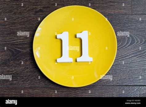 Number Eleven On The Yellow Plate And Brown Background Stock Photo Alamy