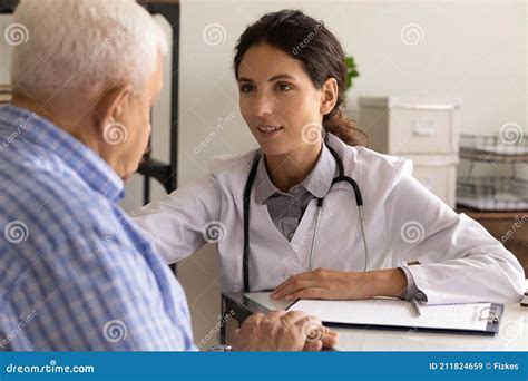 Close Up Smiling Physician Comforting Mature Patient Sharing Good News