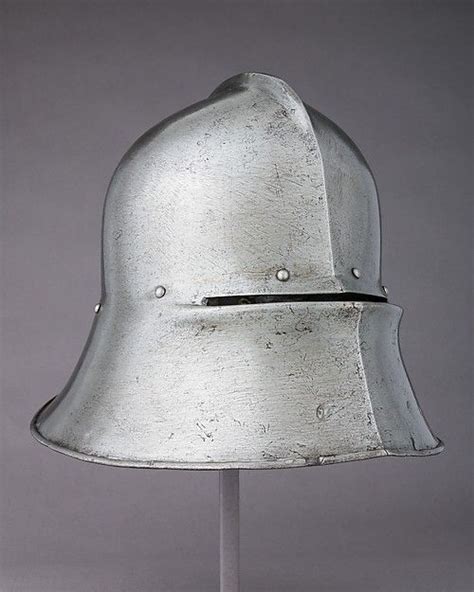 A Silver Helmet Is Shown On A Stand