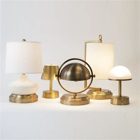 Three Lamps And One Table Lamp On A White Surface