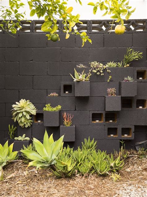 A cinder block alloy garden looks nice in front of a house with a modern design. Cinder Block Furniture - 8 Easy DIY Ideas - Bob Vila