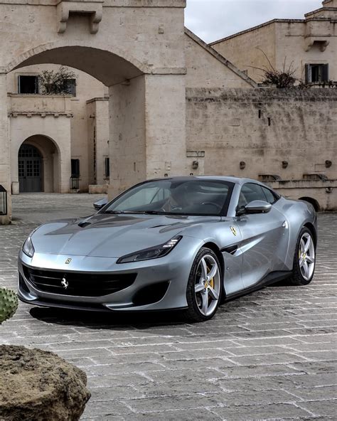A Silver Sports Car Parked In Front Of A Building