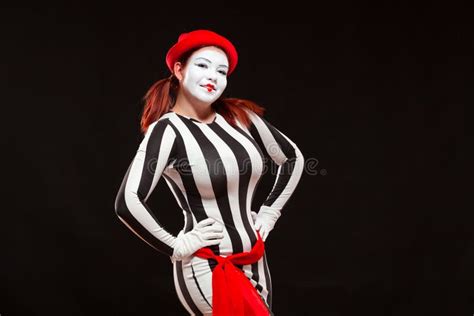 Portrait Of Female Mime Artist Performing Isolated On Black Background