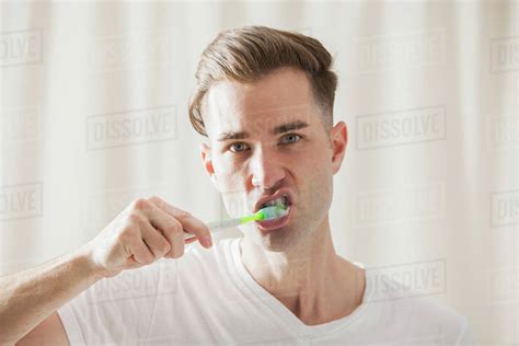 Caucasian Man Brushing His Teeth Stock Photo Dissolve