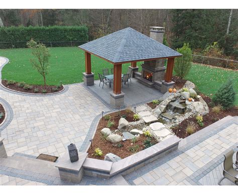 Raised Concrete Paver Patio With Outdoor Kitchen Landscaping Lighting