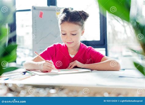 Little Girl Sitting At Desk And Drawing In Office Stock Photo Image