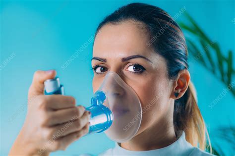 woman using inhaler for asthma stock image f027 6978 science photo library