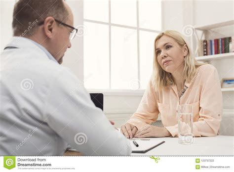 Serious Doctor Consulting Woman In Hospital Stock Photo Image Of