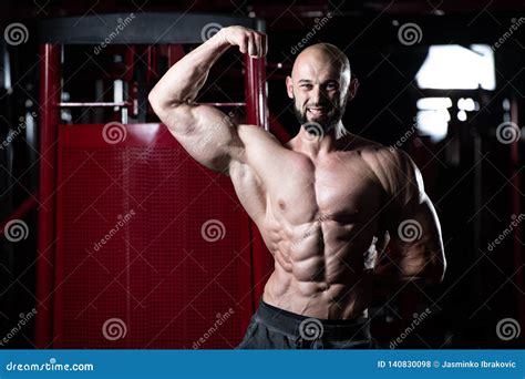 Muscular Man Flexing Muscles In Gym Stock Photo Image Of Headed Bald