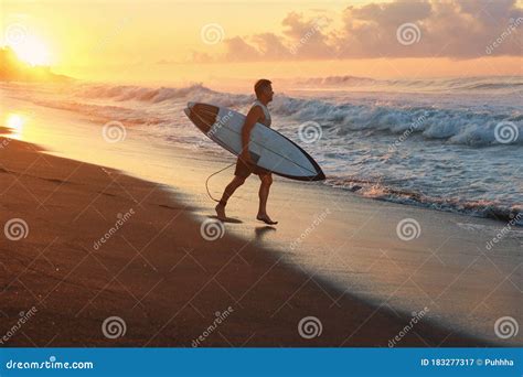 Surfer Surfing Man With White Surfboard Going To Surf On Ocean Waves